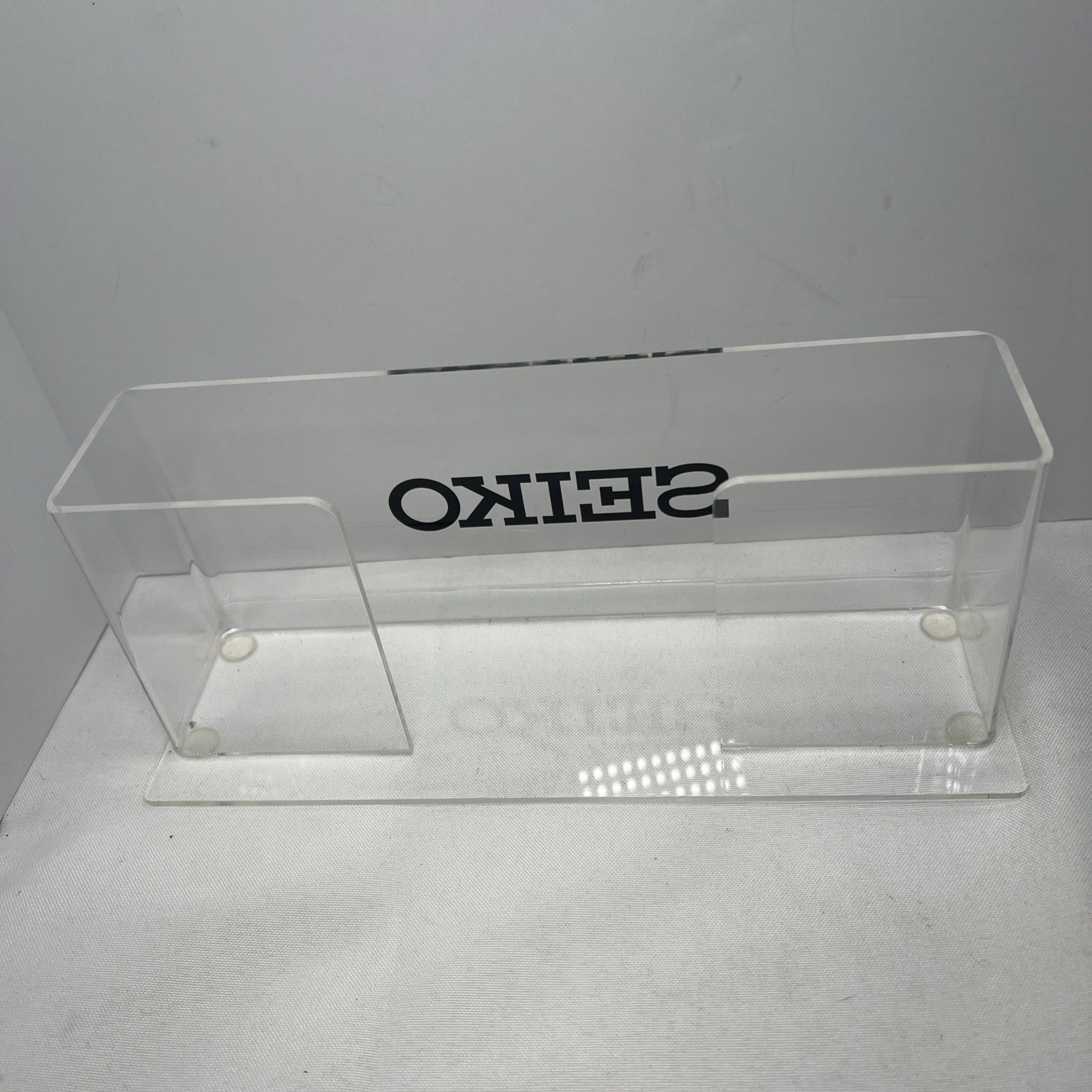 clear acrylic Seiko branded display holder 9 7/8” Long – 4” Tall