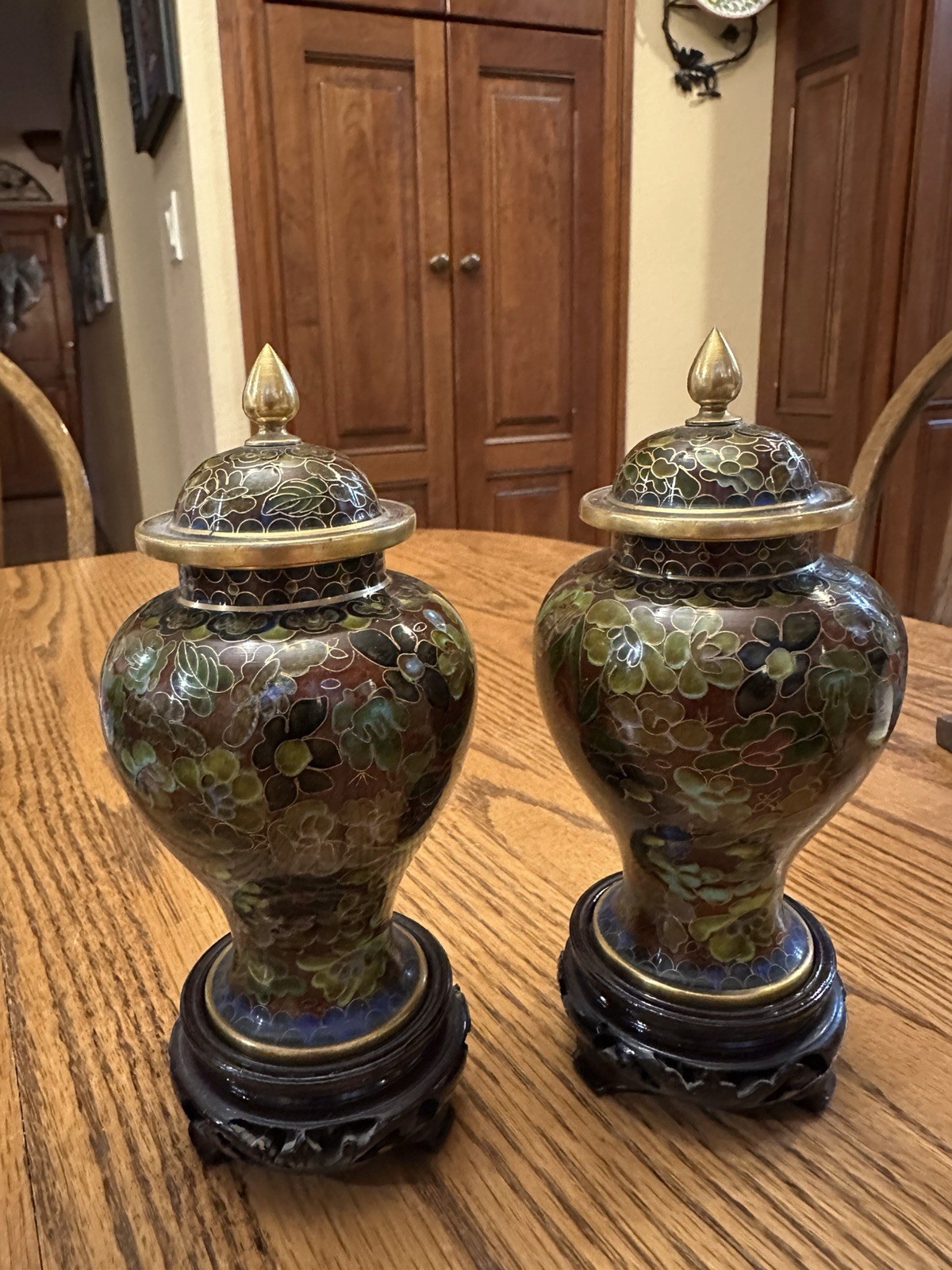 vintage Chinese cloisonné lidded vases features dark floral carved wooden stands