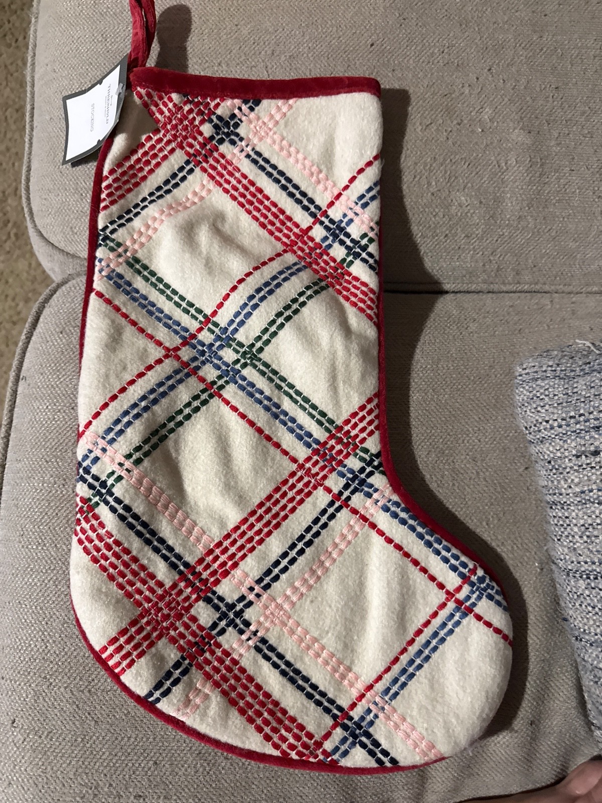 White with red green blue and pink plaid striped stocking for Christmas