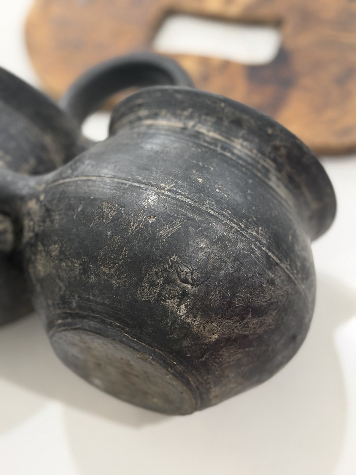 antique,specifically a ceramic double jar with a wooden lid and a black handle.