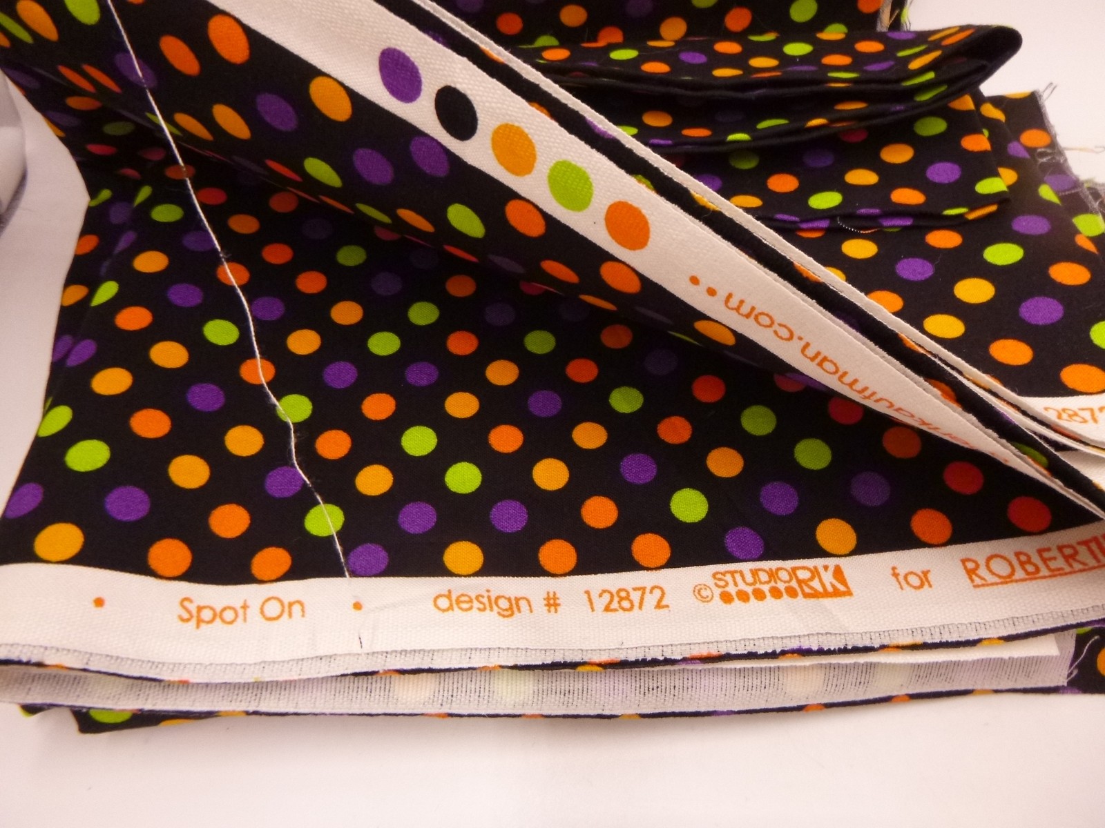 Robert Kaufman Fabric spot on black w/ orange green purple yellow dots 44″x 80″